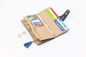 Detailed interior of women's long leather wallet with card slots and blue tassel zipper