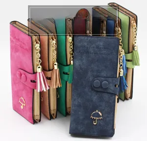Close-up of stacked vintage long wallets in colorful matte leather with tassel detail