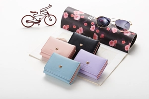 Detailed flat lay of compact tri-fold PU leather wallets in pink, black, blue, and purple
