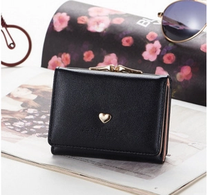 Detail of black tri-fold PU leather wallet with gold heart accent and metal frame closure