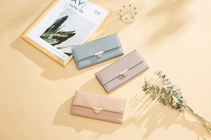 Detailed shot of long leather wallets in various colors with heart-shaped gold clasps