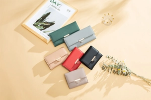 Flat lay of colorful women wallets with heart-shaped gold buckles and leather texture