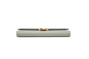 Detailed view of long leather wallet with elegant golden H-shaped metal buckle and stitching
