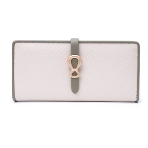 Close-up of contrast color wallet with cross-grain texture and golden bow buckle