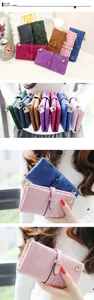 Close-up of matte vintage long wallets in various colors with metal buckles and zippers