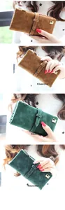Close-up showing the matte leather texture and metal buckle detail of a long clutch wallet