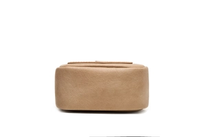 Detail view of the bag's base showing premium litchi grain texture and clean edge oiling