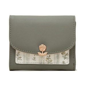 Close-up of rose gold flower clasp on green floral leather wallet with stitching details