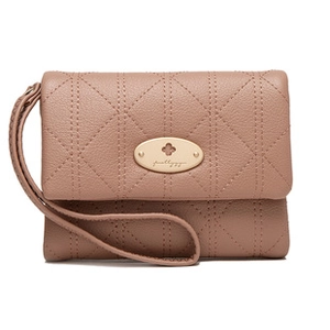 Detail of pink quilted wallet with pebble grain leather and golden floral metal plaque