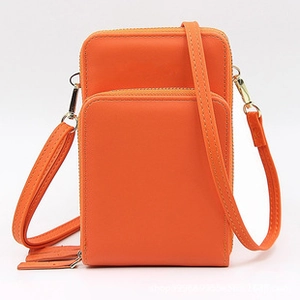Detail of vibrant orange PU leather mini crossbody wallet with double gold zippers