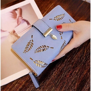Light blue long leather wallet for women with cutout leaf pattern and gold metal pendant