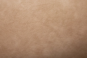 Detailed macro view of the premium matte suede texture on a vintage mini crossbody phone bag