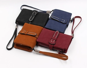 Short women wallets in four colors featuring contrast stitching and wrist straps