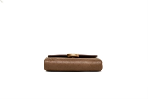 Close-up of brown pebbled leather texture and embossed floral pattern on retro wallet
