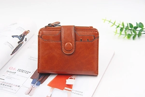 Detailed view of brown PU leather women's wallet with metal zipper and card slots
