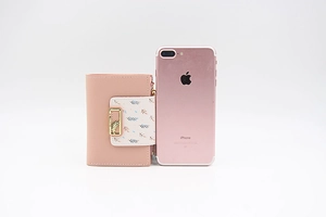 Close-up of pink PU leather wallet with floral leaf pattern and metal hardware detail