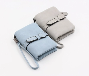 Detail view of light blue and grey bifold wallets with wrist straps and contrast stitching