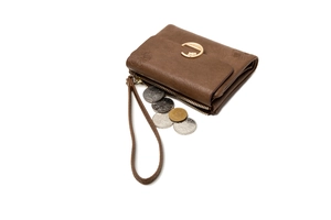 Close-up of vintage brown leather wallet with embossed floral pattern and coin storage detail