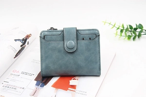 Short PU leather wallet for women with zipper and snap closure on a clean lifestyle background