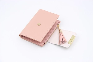 Detailed close-up of pink PU leather wallet with golden zipper and elegant tassel accent