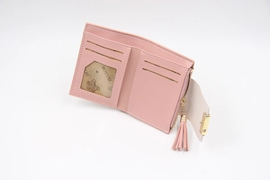Detailed interior of pink PU leather short wallet with card slots and tassel charm