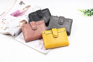 Detail showing colorful PU leather wallets with multiple card slots and secure zippers