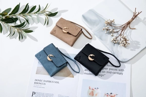 Three compact frosted leather wallets in black, blue, and khaki with gold metal buckles