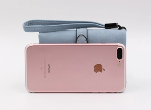 Light blue faux leather mini wallet size comparison with a rose gold smartphone