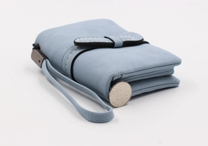 Detail of light blue folding wallet with thick white stitching and matching hand strap