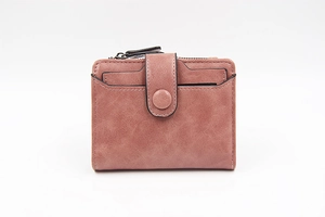 Detail of dusty pink PU leather fold wallet featuring zip pocket and snap closure