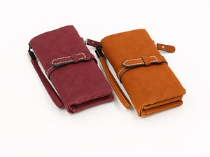 Detail of burgundy and yellow matte long wallets with stitching and wrist strap