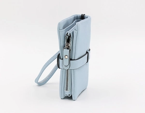 Detail of light blue women's bifold wallet with smooth leather texture and wristlet strap