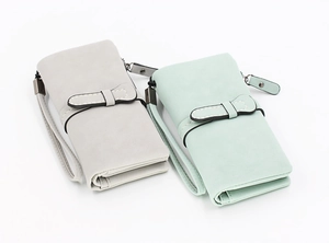 Detail of grey and mint green long PU leather wallets with elegant bow buckle and wrist strap