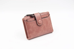 Detail view of dusty pink PU leather wallet with card slots and metal zipper pocket