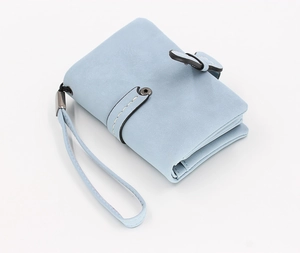 Detail view of light blue matte wallet with hand strap and contrast stitching