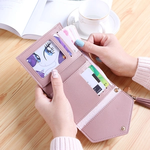 Pink PU leather tri-fold heart tassel wallet shown unfolded with multiple card slots