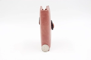 Detailed side view of slim pink PU leather wallet showing precise stitching and thickness