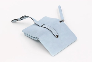 Close-up of light blue leather wallet with button closure and fine white stitching detail