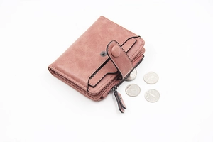 Close-up of compact PU leather wallet with side zipper and card slots in dusty rose