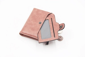 Detail showing the inner transparent card slot and textured pink PU leather of the wallet