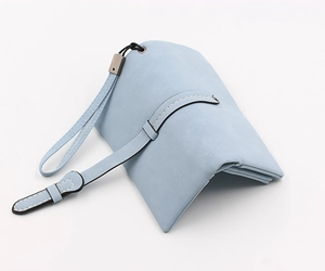 Detail of light blue faux leather wallet featuring exquisite white stitching and wrist strap