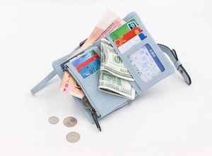 Light blue compact folding wallet showing card slots, bill layer and clear ID window