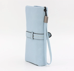 Detail of sky blue matte leather wallet with white stitching and wrist strap connector