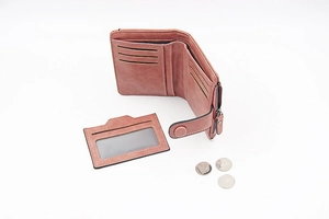Detail view of dusty rose PU leather wallet with detachable card slot and zipper pocket