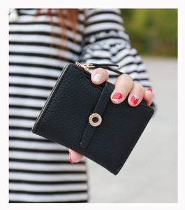 Close-up of black litchi pattern leather wallet with golden ring buckle and zipper