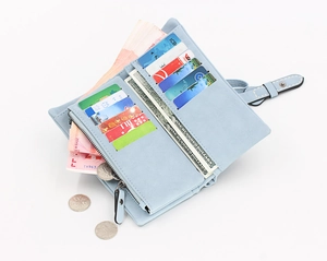 Detail view of light blue long wallet showing multi-slot card holder and zipper pocket