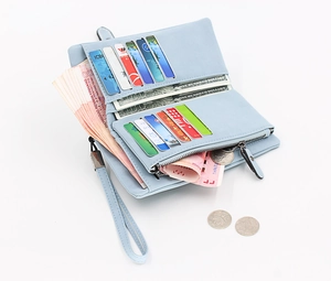 Detail view of light blue long wallet with multi-card slots and zippered coin pocket
