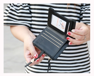 Detailed view of the black leather wallet interior featuring card slots and a clear ID window