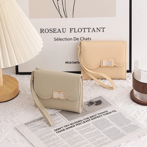 Detail of compact PU leather wallets with elegant metal M-buckle and wrist straps
