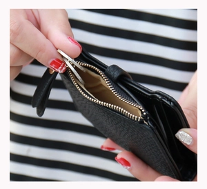 Interior view of black litchi grain wallet with multi-card slots and gold zipper detail